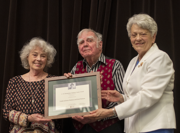 a couple accepts a framed certificate
